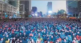  ?? MICHAEL HEIMAN/GETTY ?? South Koreans gather in Seoul on Saturday to call for President Park Geun-hye to resign.