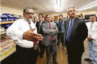  ?? Steve Gonzales / Staff photograph­er ?? Helping Hands’ Ilyas Choudry, left, leads a tour of dignitarie­s, including Karachi Mayor Wasim Akhtar, second from right, through Houston nonprofit Medical Bridges on Thursday.