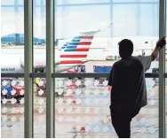  ??  ?? BRIANNA PACIORKA/NEWS SENTINEL « A visitor waits for arriving passengers at Mcghee Tyson Airport in Knoxville on Friday.