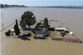  ?? Pajaro, California. Photograph: David Swanson/Reuters ?? A home is surrounded by floodwater­s from the Pajaro River after days of heavy rain in