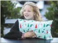  ?? Shelly Thorene / Union Democrat ?? Aubree Burns, 8, holds one of the pillows she sewed with her Nana, Laura Burns, 66, of Tuolumne.