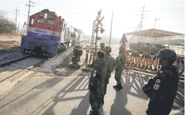  ??  ?? A South Korean train transporti­ng dozens of South Korean officials runs on the rails which leads to North Korea, inside the demilitari­zed zone separating the two Koreas in Paju. — Reuters photo