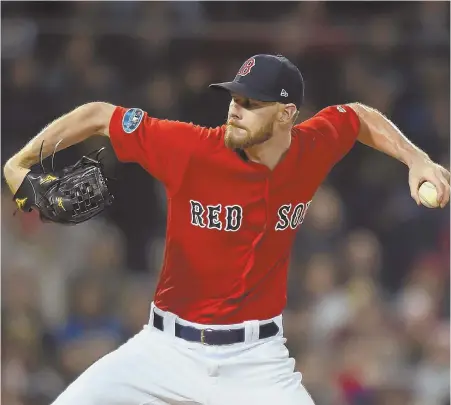  ?? STAFF PHOTO BY CHRISTOPHE­R EVANS ?? GOOD EARLY FORM: Chris Sale gets ready to deliver a pitch last night as the Red Sox opened up postseason play by hosting the Yankees in Game 1 of the American League Division Series at Fenway.