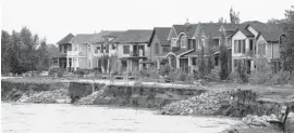  ?? The Canadian Press/files ?? One simple way to mitigate flood damage would have been to order a halt to developmen­t on flood plains. But riverside homes are popular with both buyers and developers.