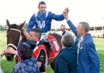  ?? PHOTO: GETTY IMAGES ?? Hugh Bowman celebrates with Winx’s owners after her third Cox Plate triumph.