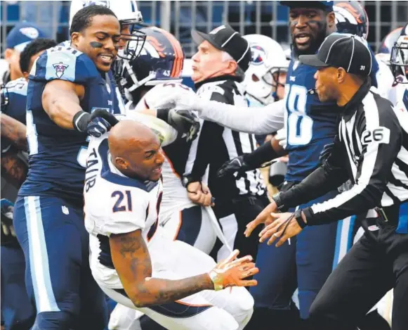  ??  ?? Avery Williamson, left, of the Titans throws Broncos cornerback Aqib Talib out of the pile after a tussle with Tennessee wide receiver Harry Douglas during the second quarter Sunday. Talib was retaliatin­g for what he considered a cheap shot by Douglas on Denver cornerback Chris Harris. Joe Amon, The Denver Post