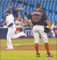  ?? Fred Thornhill / Associated Press ?? Red Sox starting pitcher Eduardo Rodriguez watches the Blue Jays’ Rowdy Tellez round the bases on a home run during the fifth inning on Tuesday in Toronto.