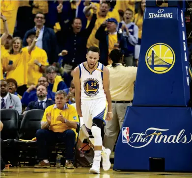  ??  ?? Stephen Curry had a triple double in Game 2 of the Finals, above. Right, the Cavs’ LeBron James, covered by Curry and Draymond Green in Game 1, scored 28 points — his lowest total in the series.