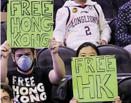  ?? AFP ?? PROTESTERS were kicked out of the game between the Philadelph­ia 76ers and Guangzhou Lions.