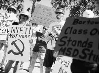  ?? JOE RAEDLE
GETTY IMAGES FILE PHOTO ?? Activists protest in front of gun manufactur­er Kalashniko­v USA in Florida after the mass shooting at Marjory Stoneman Douglas High School on Feb. 14. Nobody knows how many students get caught with guns in school.