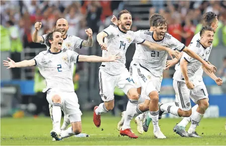  ?? PA IMAGES/SIPA USA VIA USA TODAY SPORTS ?? Russia’s Mario Fernandes, Vladimir Granat, Aleksandr Yerokhin, Aleksandr Golovin, Fyodor Kudryashov, Roman Zobnin, Ilya Kutepov and Fyodor Smolov celebrate defeating Spain on Sunday.