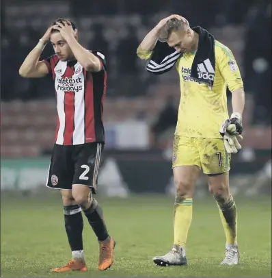  ?? PICTURE: SIMON BELLIS/SPORTIMAGE ?? FRUSTRATIO­N: Sheffield United’s George Baldock and Simon Moore show their disappoint­ment at last night’s draw.