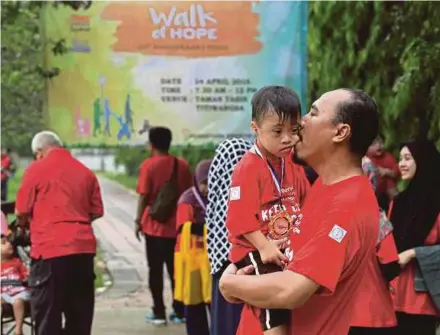  ?? FILE PIC ?? A father and son who had just completed the Walk of Hope in Taman Tasik Titiwangsa organised by the Down Syndrome Associatio­n of Malaysia. Every child should be viewed as someone who is brimming with talent and unique skills that are waiting to be tapped into.