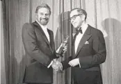  ?? AP ?? Walter Mirisch (right) and Charlton Heston celebrate at the 34th annual Golden Globes in 1977.