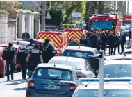  ?? (Gonzalo Fuentes/Reuters) ?? POLICE OFFICERS secure the area in Rambouille­t, France on Friday where an attacker stabbed and killed a female police administra­tive worker.