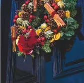  ??  ?? This stylish wreath shouts Christmas, but to work as a cover it needs to be a little lower in the frame