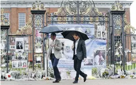  ?? — GETTY IMAGES ?? Prince William and Prince Harry looked over tributes to Princess Diana left at one of the entrances to Kensington Palace to mark the coming 20th anniversar­y of her death.