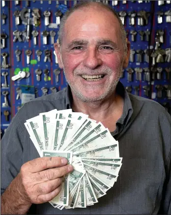  ??  ?? Quid’s out: Ronnie Kerr, who only gives out Scottish pound notes as change in his shop