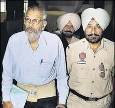  ?? PTI FILE ?? Maoist leader Kobad Ghandy being escorted by a police personnel to a district court complex in Patiala in October last year.