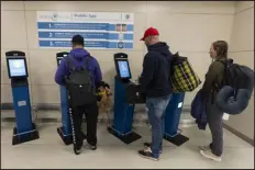  ?? MANUEL BALCE CENETA — THE ASSOCIATED PRESS ?? Internatio­nal travelers use the portal to get their initial processing and instructio­ns on their next procedure in the port of entry at Washington Dulles Internatio­nal Airport.