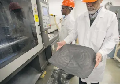  ?? PHOTOS: LAURA PEDERSEN / NATIONAL POST ?? Muhammad Pervaiz holds a seat bottom for a chair that was created from a wood pulp-based compound at the University of Toronto’s Faculty of Forestry. Similar compounds can be used in car parts, dean Mohini Sain says.