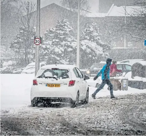  ?? ?? WEATHER WARNING: Shoppers nip out to collect some essentials from the Food Warehouse in Glenrothes during Storm Darcy in February this year. Heavy snow is expected in Perthshire as Storm Barra rolls in tomorrow, just as power has finally been restored to all homes after Storm Arwen.