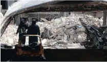  ??  ?? DEVASTATIO­N: Women walk past damage near al-Quds hospital after it was hit by air strikes.