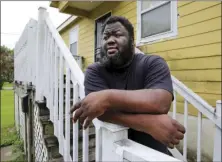  ?? AP PHOTO/RUSTY COSTANZ ?? Shaun Mills, who is currently furloughed from his job due to COVID-19, stands in front of his home in New Orleans, Wednesday. Even before he lost his line-cook job, he said, he struggled. “The prices of your rent, the prices of the insurance, the living expenses, the food expenses. Everything goes up year after year except for the pay,” he said.