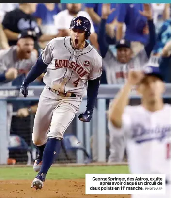  ?? PHOTO AFP ?? George Springer, des Astros, exulte après avoir claqué un circuit de deux points en 11e manche.