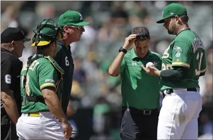  ?? BEN MARGOT — THE ASSOCIATED PRESS ?? A’s starter Brett Anderson, right, has his finger inspected by a trainer as manager Bob Melvin, center, looks on during Sunday’s loss to Houston.