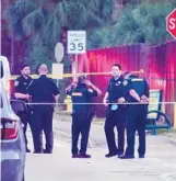  ?? JOE CAVARETTA/ SOUTH FLORIDA SUN SENTINEL ?? Deputies gather Sunday outside Florida Medical Center in Lauderdale Lakes after a deputy fired at a driver who was heading toward Lauderhill officers. The chain of events was preceded by a morning shooting at a strip club, authoritie­s said.