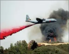  ?? NOAH BERGER — THE ASSOCIATED PRESS ?? An air tanker drops retardant on the River Fire burning near Lakeport on Tuesday.