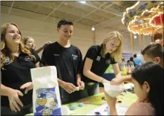  ??  ?? LEFT TO RIGHT: 4-H members Abby Hester, 14, Andrew Angulo, 13, and Hannah Cartee, 15, show Jacob Hernandez, 7, and Jazlyn Valles, 6, how to make a balloon project during the fourth annual 4-H Kick Off and Spark Fair at the Imperial Valley Mall in El...