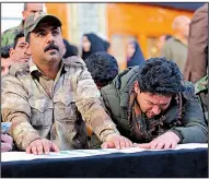  ?? AP/ANMAR KHALIL ?? Mourners pray Monday in Najaf, Iraq, over the flag-draped coffin of Ismail Mahmoud, 24, a fighter with the Popular Mobilizati­on Forces who was killed Sunday in an attack southwest of the northern city of Kirkuk.