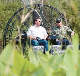  ?? WILFREDO LEE/AP ?? Then-gubernator­ial candidate Ron DeSantis, left, chats with “Alligator Ron” Bergeron during an airboat tour of the Florida Everglades in September 2018. DeSantis appointed Bergeron to the South Florida Water Management District board in February 2019.