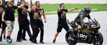  ??  ?? You go, guy: Italian Moto2 rider Francesco Bagnaia celebratin­g with his team members after winning the world title during the Shell Malaysia Motorcycle Grand Prix at the Sepang Internatio­nal Circuit yesterday.
