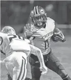  ?? JEFF FAUGHENDER/COURIER JOURNAL ?? Atherton wide receiver James Allen Briscoe, Jr. stiff-arms a Fairdale defender as Atherton defeats Fairdale 24-6 to clinch the 5A, District Three title on Friday.