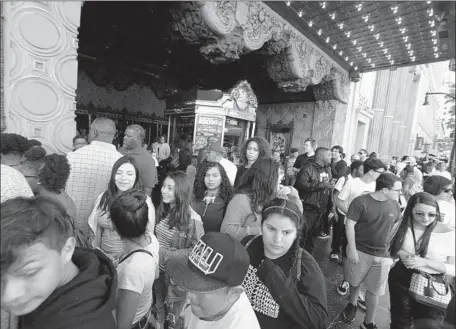  ?? Genaro Molina Los Angeles Times ?? FANS pack sidewalk outside El Capitan Theatre in Hollywood after seeing “Black Panther” on Saturday as others await the next showing.