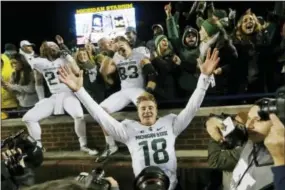  ?? CARLOS OSORIO — THE ASSOCIATED PRESS ?? Michigan State quarterbac­k Connor Cook (18) celebrates with teammates and fans after their 27-23 win over Michigan on Saturday.