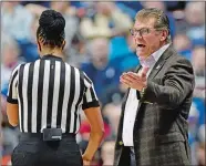  ?? SEAN D. ELLIOT/THE DAY ?? UConn’s coach Geno Auriemma protests a call to official Nykeesha Thompson, left, during an AAC tournament game against Tulane on March 4 at Mohegan Sun Arena.