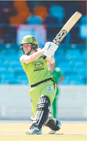  ?? ?? Former Australian cricket captain Alex Blackwell (main, on right) with her wife Lynsey Askew and their dog Joni; and (above) Blackwell bats for the Sydney Thunder during a Women’s Big Bash League match against the Melbourne Stars in Canberra in 2019.