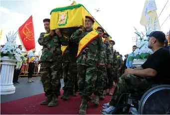  ?? (Reuters) ?? HEZBOLLAH MEMBERS carry the coffin recently of a senior commander near Nabatieh in southern Lebanon.