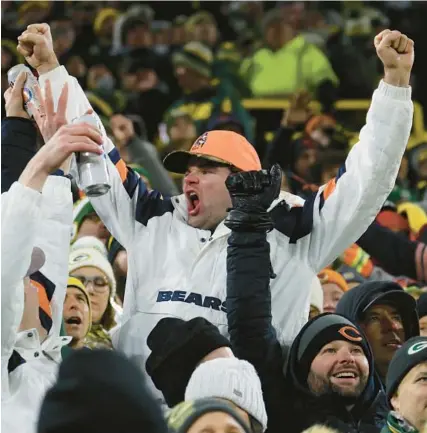  ?? JOHN J. KIM/CHICAGO TRIBUNE ?? Bears fans celebrate after a Packers touchdown call is overturned after video review in the fourth quarter Jan. 7 at Lambeau Field in Green Bay.