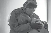  ?? GO NAKAMURA/ GETTY IMAGES ?? Dr. Joseph Varon hugs and comforts a patient in the COVID-19 intensive care unit (ICU) on Thanksgivi­ng at the United Memorial Medical Center in Houston, Texas.