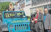  ?? SUBMITTED PHOTO ?? Grass Roots and Cowboy Boots organizer Warren Ellis, second right, and his dog, Baby, are joined by Brody Ellis and Sheila Taweel of Summerside Chrysler Dodge in donating the new Jeep Wrangler Sport to Patrick McSweeny, PCH Foundation president. This Jeep will be won by one of the ticket buyers for the event to be held Sept. 9 at Credit Union Place in Summerside.
