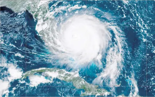  ?? GETTY ?? Hurricane Dorian, now a Cat. 4 storm, moves slowly past Grand Bahama Island on Monday in this satellite image. The storm’s likely path inched slightly farther from South Florida.