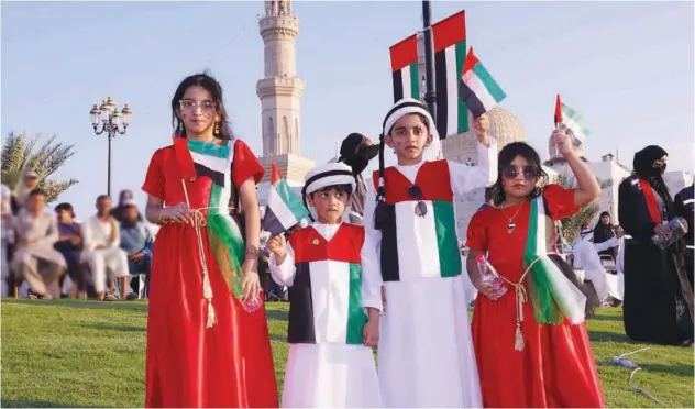  ?? ?? ↑
Children show their love for their country during the National Day celebratio­ns in Dibba Al Hisn, Sharjah.