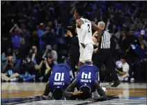  ?? CHRIS SZAGOLA — THE ASSOCIATED PRESS ?? Saint Peter’s Fousseyni Drame (10) and Hassan Drame (14) react past Purdue’s Eric Hunter Jr. (2) after Saint Peter’s won in the Sweet 16 round of the NCAA Tournament on Friday in Philadelph­ia.