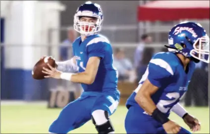  ?? PHOTO SERGIO BASTIDAS ?? Central quarterbac­k Deniro Osuna (11) looks downfield ahead of a pass during the Spartans’ game against Gila Ridge. Osuna threw for 209 yards and two TDs against the Christian Patriots on Friday, but the Spartans fell for the second week in a row, 31-28.