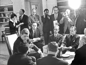  ?? Byron Rollins/Associated Press ?? President John Kennedy meets with Civil Rights Commission members, including presidenti­al aide Harris Wofford, to the president’s right, on Nov. 22, 1961, at the White House.